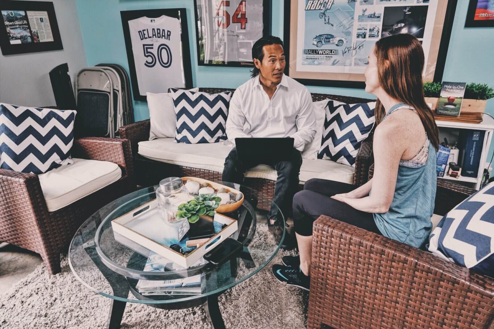 Two people having a conversation in a cozy living room setting.
